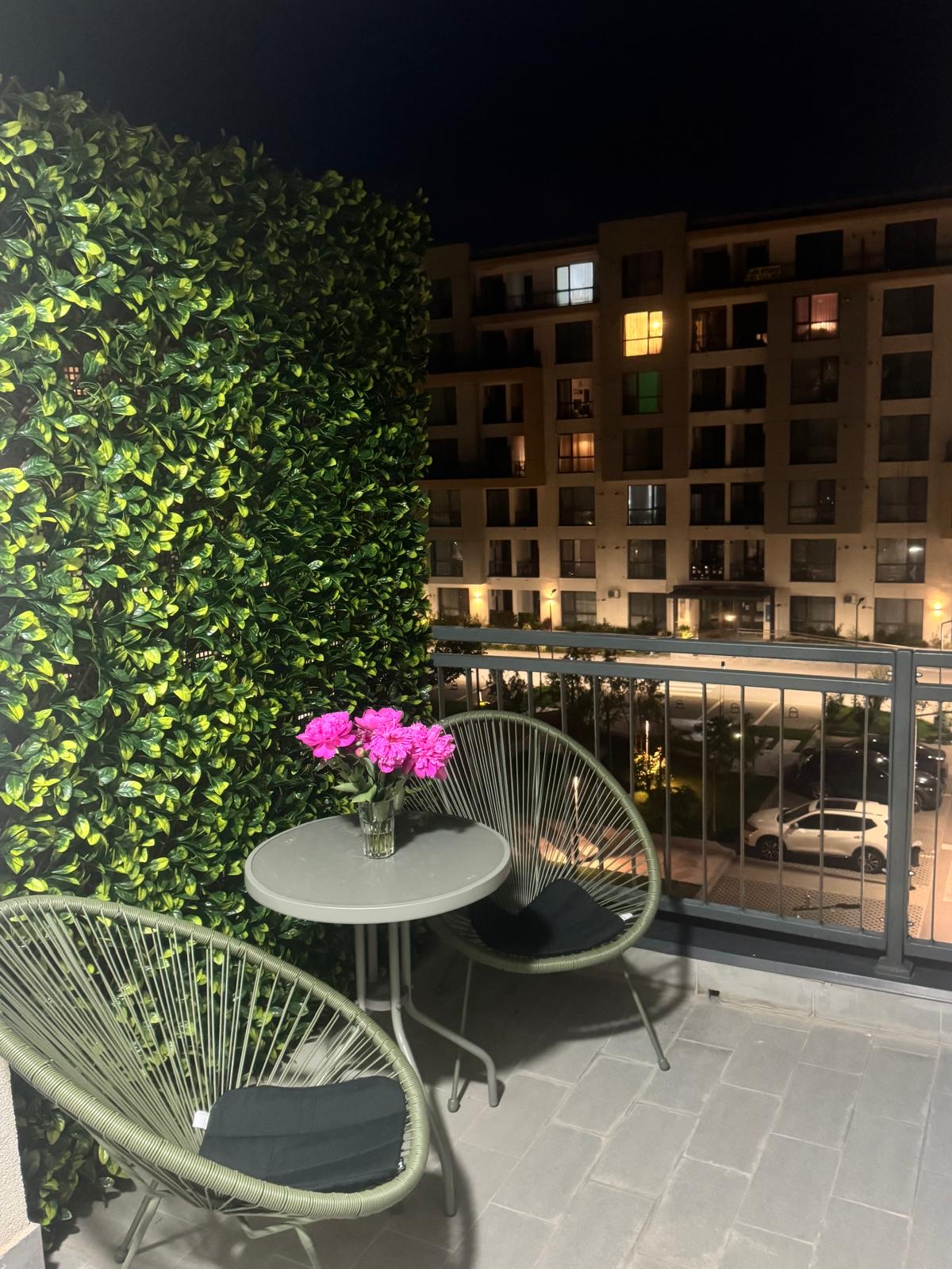 Balcon cu fotolii și flori, seara